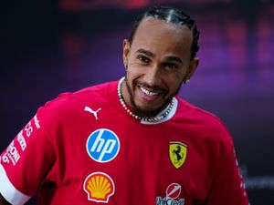 Lewis Hamilton smiles in a Ferrari t-shirt