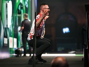 Damon Heta celebrates his nine-dart finish