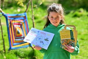 Nancy Shropshire, 7, with seeds that pupils have grown in the Easter holidays.