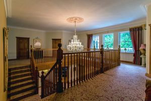 An oak balcony staircase leading up to the second floor