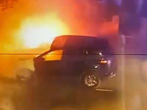 A burning car on a street