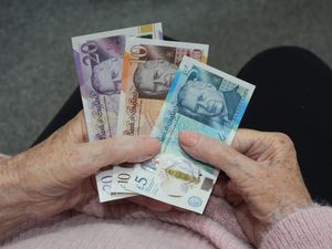 A pensioner holding bank notes