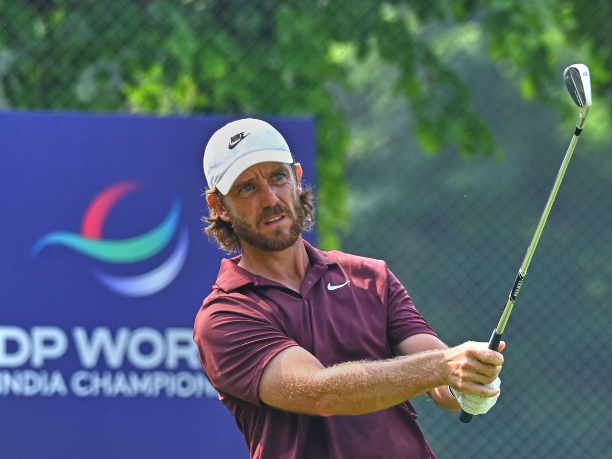 Tommy Fleetwood celebrates with son on 18th green after victory in Delhi