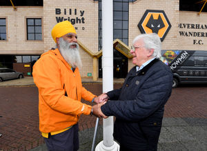 Tony Perry greets Manny next to the Billy Wright statue