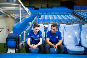 Ed Garside and Gianfranco Zola chat in the Chelsea dug outs
