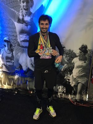 Nathan Judah smiles with his Dopey Challenge medals