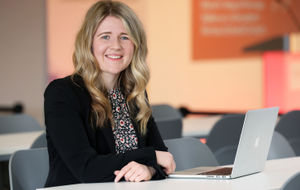 Marketing assistant apprentice Elinor Jones with her laptop at the NTFW conference and taking part in the Apprentice Spotlight