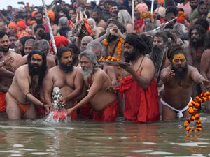 Hindu holy men perform rituals at the confluence of the Rivers Ganges, Yamuna and mythical Saraswati during the Maha Kumbh festival in Prayagraj, India