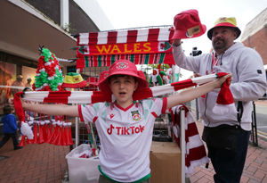Wrexham fan Riley Edwards waves a scarf ahead of the victory parade in Wrexham
