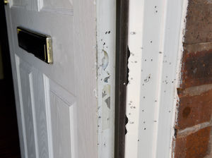 Holes can be seen in the front door and frame