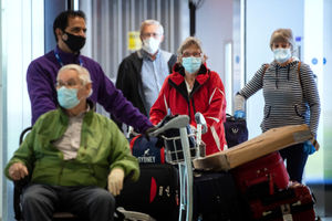 Passengers from the Holland America Line ship Zaandam walk through arrivals in Terminal 2 at Heathrow Airport in London, after flying back on a repatriation flight from Florida

