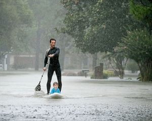 Alexendre Jorge helps evacuate four-year-old Ethan Colman
