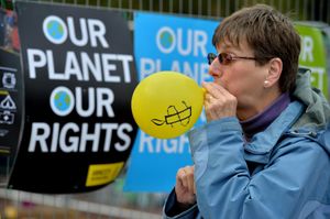 Maggie Marriott from Wolverhampton blows up an Amnesty balloon at the event