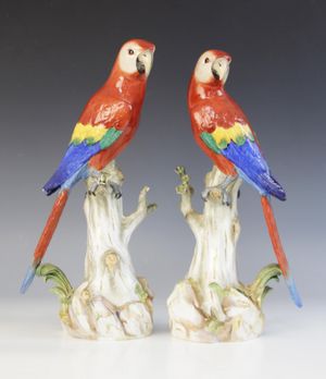 A pair of vibrant porcelain parrots by renowned German porcelain factory Meissen