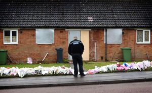 A police officer stands over the tributes in Valley View, Brownhills