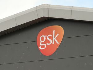 A GSK sign on a production building