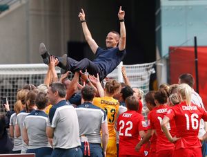 England coach Mark Sampson is picked up by his players