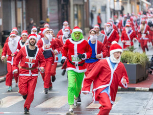 Supporting image for story: In pictures: 500 Santas take to the streets of Oswestry
