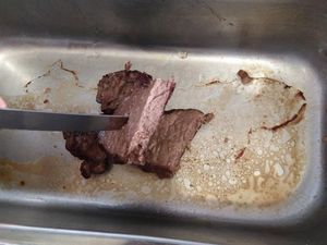 Supporting image for story: Cafe owner shows how hot car interiors get — by cooking steak on centre console