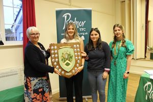 Radnor YFC President, Sharon Hammond presenting the NFU Shield to Lauren Bradford and Lowri Bayliss of Penybont YFC accompanied by County Chair, Elizabeth Swancott