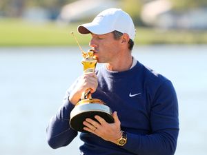 Rory McIlroy kisses the Players Championship trophy