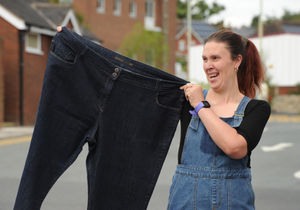 Sarah with a pair of her old jeans