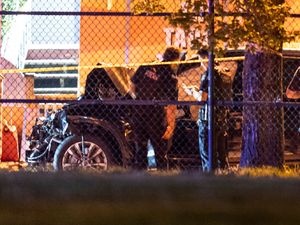 Police examine a 4x4 with a crumpled front end