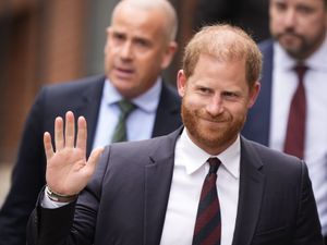 The Duke of Sussex waves as he arrives at the Royal Courts of Justice