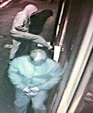 One of the men attempts to kick the door in