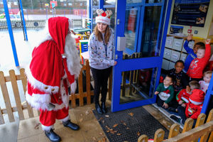 The longest serving Santa Ray Hulse, 76 from Bridgenorth has paid a socially distanced visit to Windmill Primary School in Telford to deliver goodies to the excited children. See SWNS story SWMDsanta. December 11, 2020.
