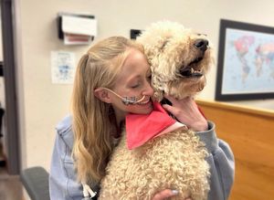 Talia with Samson the Clinic's therapy dog
