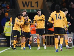 Wolves’ Rodrigo Gomes, third left, celebrates scoring their opener against Liverpool