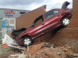 Supporting image for story: IN PICTURES: Car smashes through brick wall in town centre