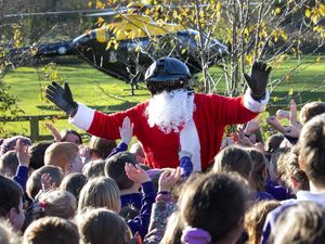 Supporting image for story: Father Christmas ditches sleigh for helicopter and takes to the skies to visit schools