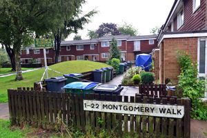 A forensic tent outside the flat Montgomery Walk
