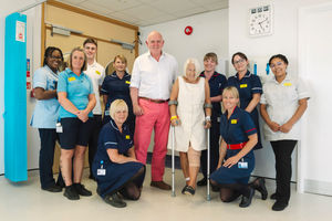 Patient Anne Long is pictured up on her feet with her consultant Mr Niall Graham, alongside members of the multi-disciplinary team who provided her care, just hours after undergoing knee replacement surgery.