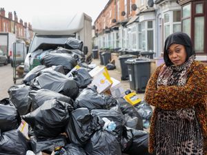 Hawida Osman local resident standing next to rubbish on Percy Road in Sparkhill Birmingham  ahead of Tuesday's 'all out strike'.  