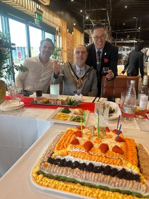 Adam Gregory, Councillor Craig Collingswood and Kan Koo raise a glass to celebrate 15 years of business in Wolverhampton