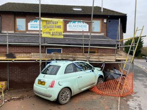 The car wedged into the wall of the vets. Photo: Mike Ford