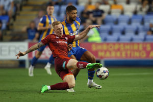 Rekeil Pyke of Shrewsbury Town and Callum Guy of Carlisle United.