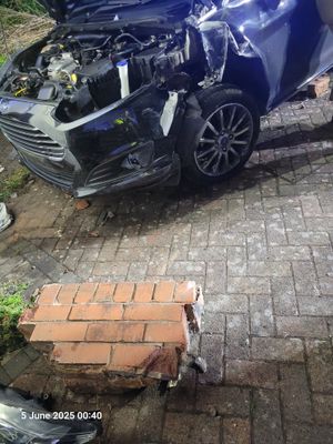 The car had gone through the wall and left damage. Photo: Dudley Fire Station