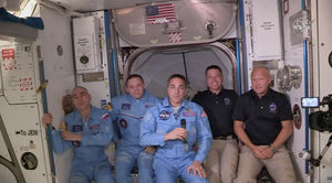 Bob Behnken and Doug Hurley, far right, join the crew at the International Space Station after the SpaceX Dragon capsule pulled up to the station