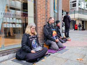 Supporting image for story: Buddhists meditate outside Shrewsbury bank in peaceful fossil fuels protest