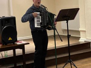 Dr Richard Churchley accompanying Christmas Songs at the Lodge.