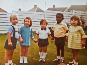Julian, centre, and Ann on the right playing as children