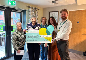 Springwood residents and staff present cheque to Severn Hospice