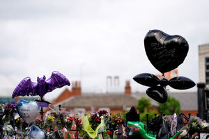 A floral tributes left at the Black Sabbath Bridge bench on Broad Street in Birmingham 