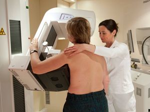 A woman undergoes breast screening