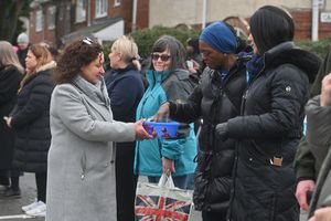 The family stop to hand out some sweets like Pat used too. In the grey and receiving the sweets was Luisa Trapani of St Mary & Johns Catholic Primary School.