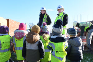 Lynette Hooper - assistant project manager, and Mike Kilner - site manager, on site with the children at Cameron Homes' Willow Rise development in Bomere Heath.